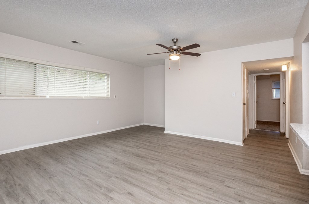 a bedroom with hardwood floors and a ceiling fan