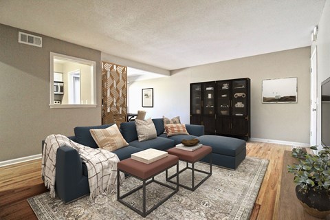 A living room with a dark blue couch and a coffee table.