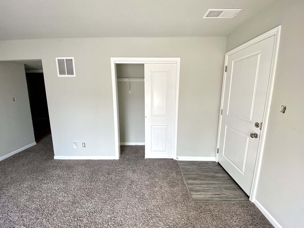 A room with a white door and a window.