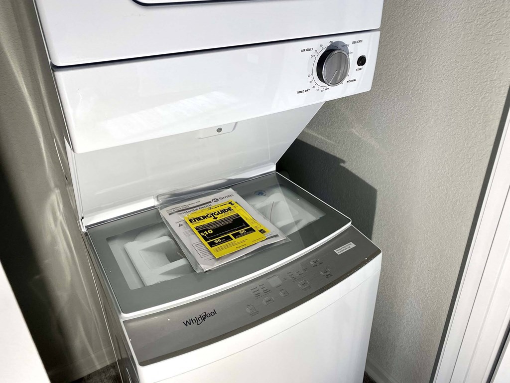 A white washing machine with a sticker on the door.
