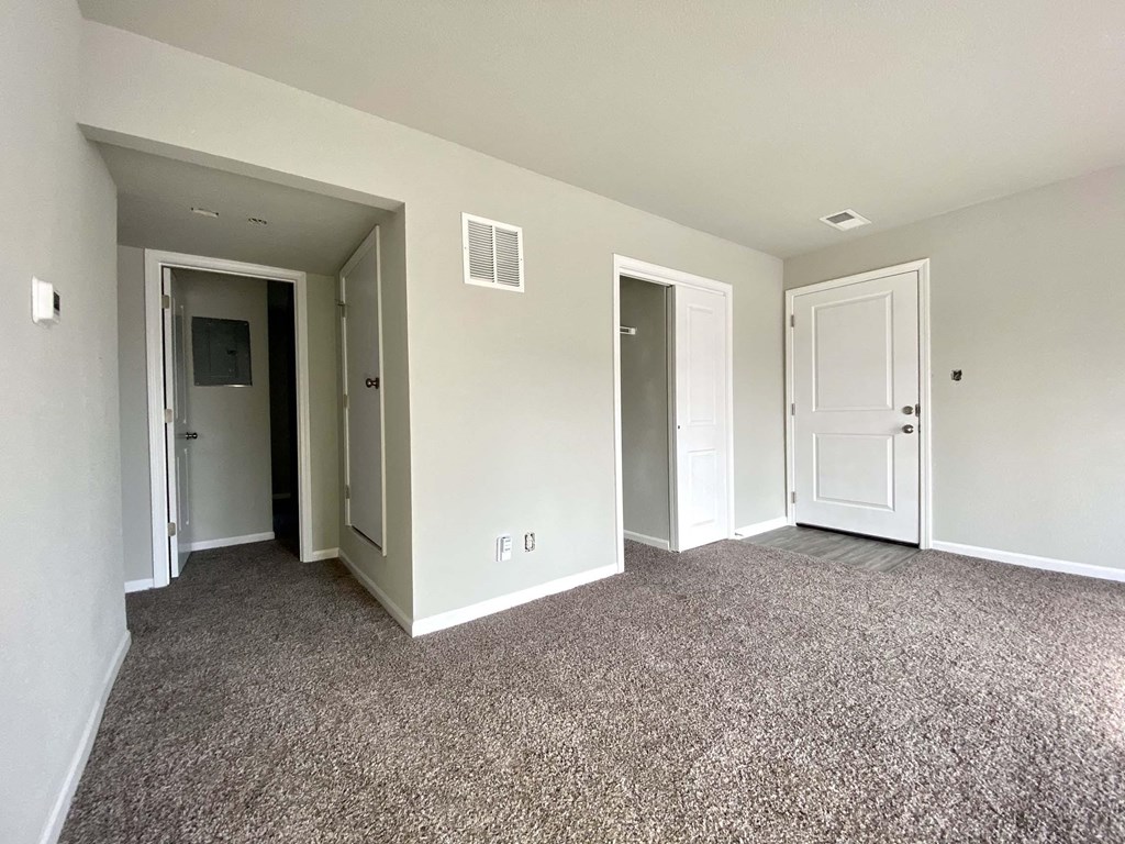 A room with carpeted floor and white walls.