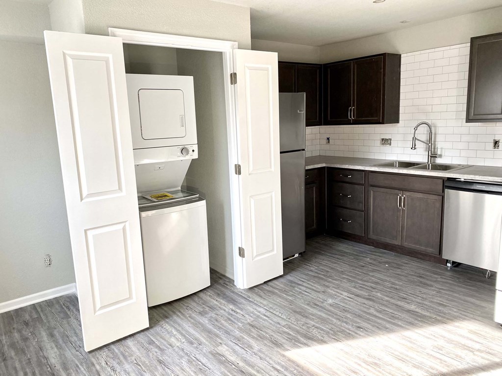 A kitchen with a white dishwasher and a white refrigerator.