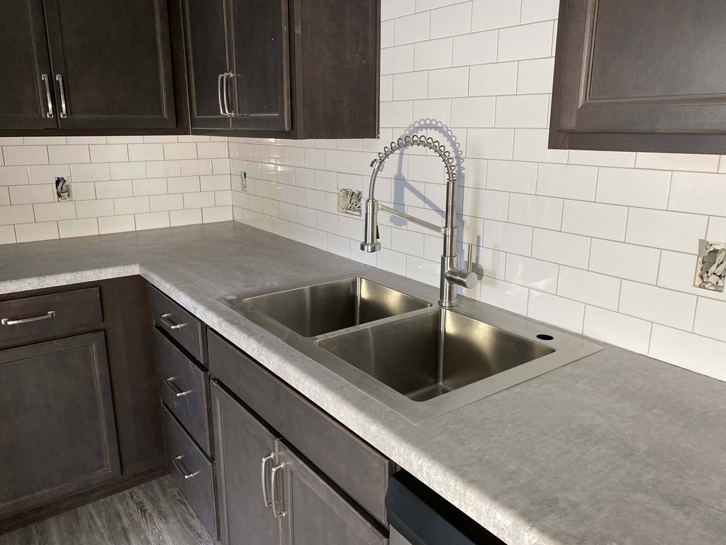 A kitchen with a sink and a faucet.