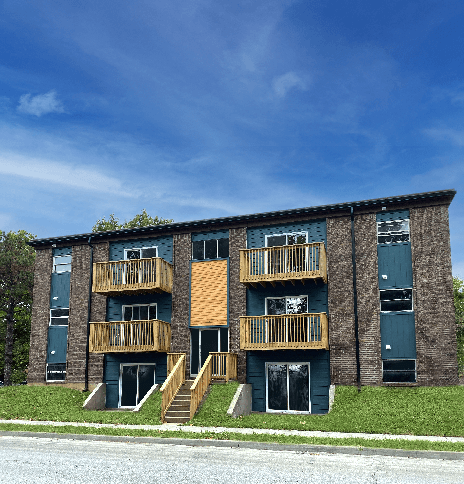 A large apartment building with a balcony on the second floor.