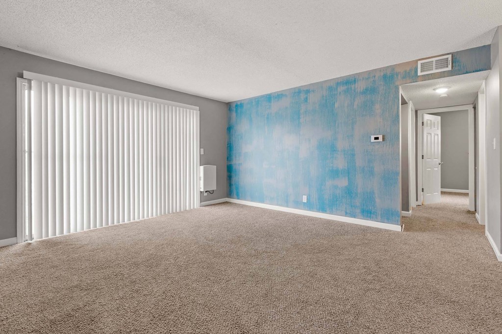 A room with a blue wall and carpet.