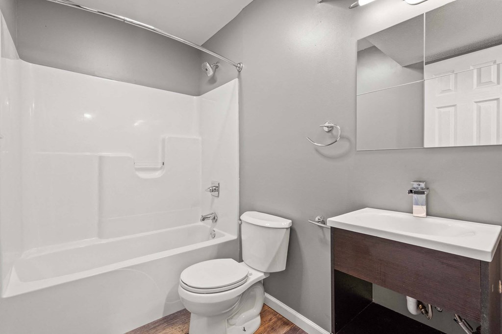 A white toilet sits next to a sink in a bathroom.