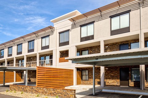 A modern building with a combination of stone and wood materials.