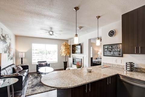 A modern kitchen and living room with a large island in the center.