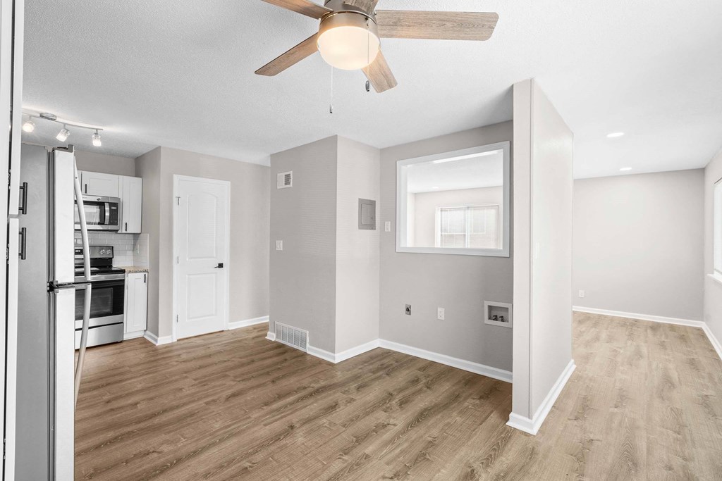 A spacious kitchen with a refrigerator, microwave, and oven.