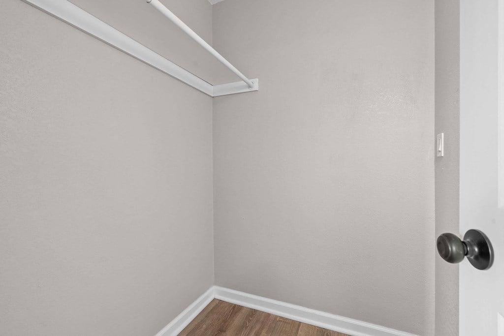 A room with a door and a shelf above it.