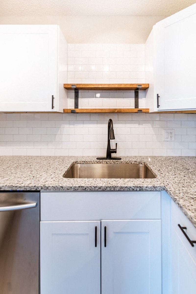A kitchen with a sink and cabinets.