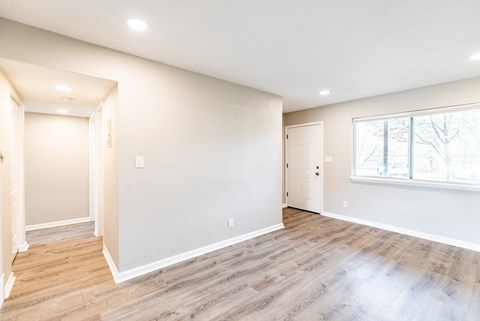 A room with a window and a door.