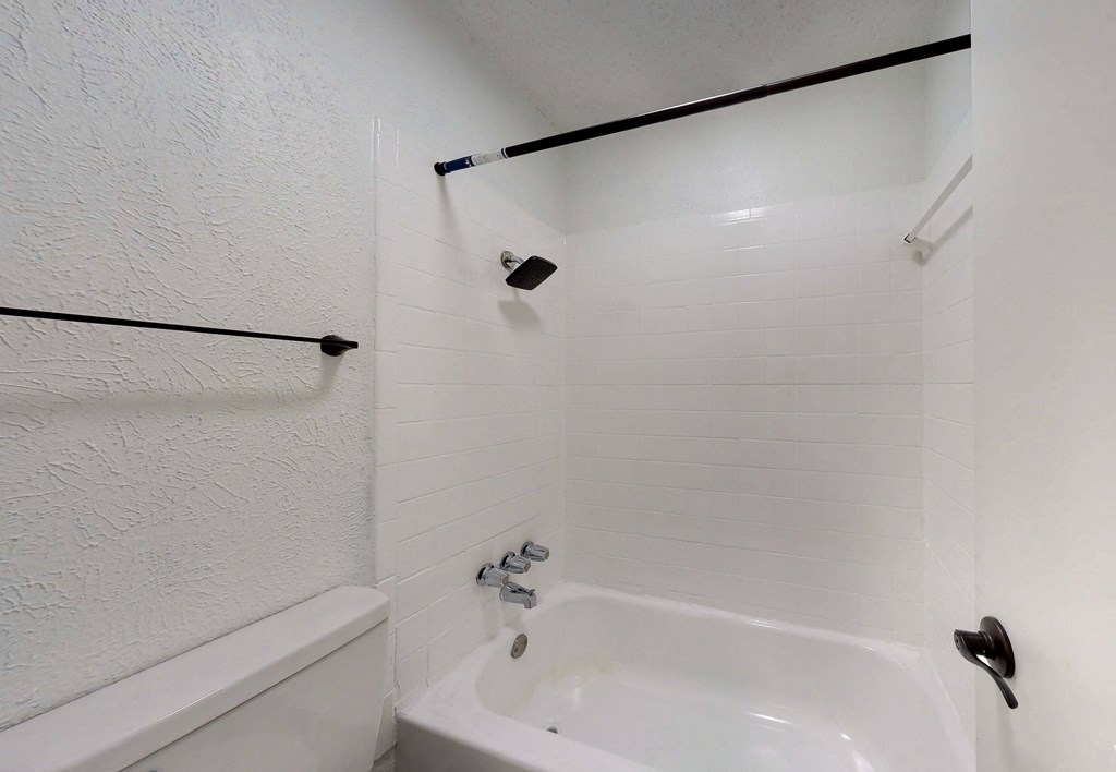 a bathroom with a sink and a tub and a toilet