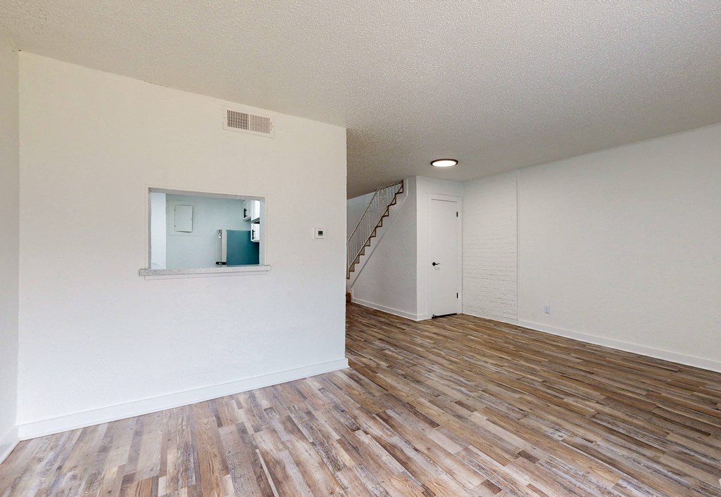 the spacious living room and dining room with hardwood flooring