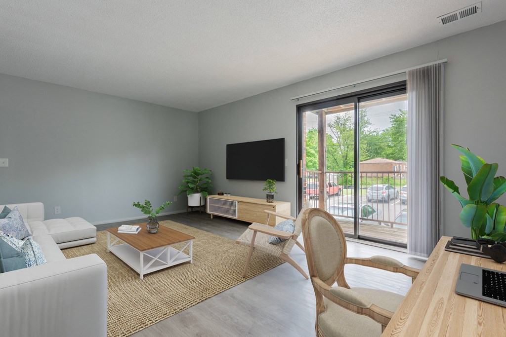 a living room with gray walls and a sliding glass door