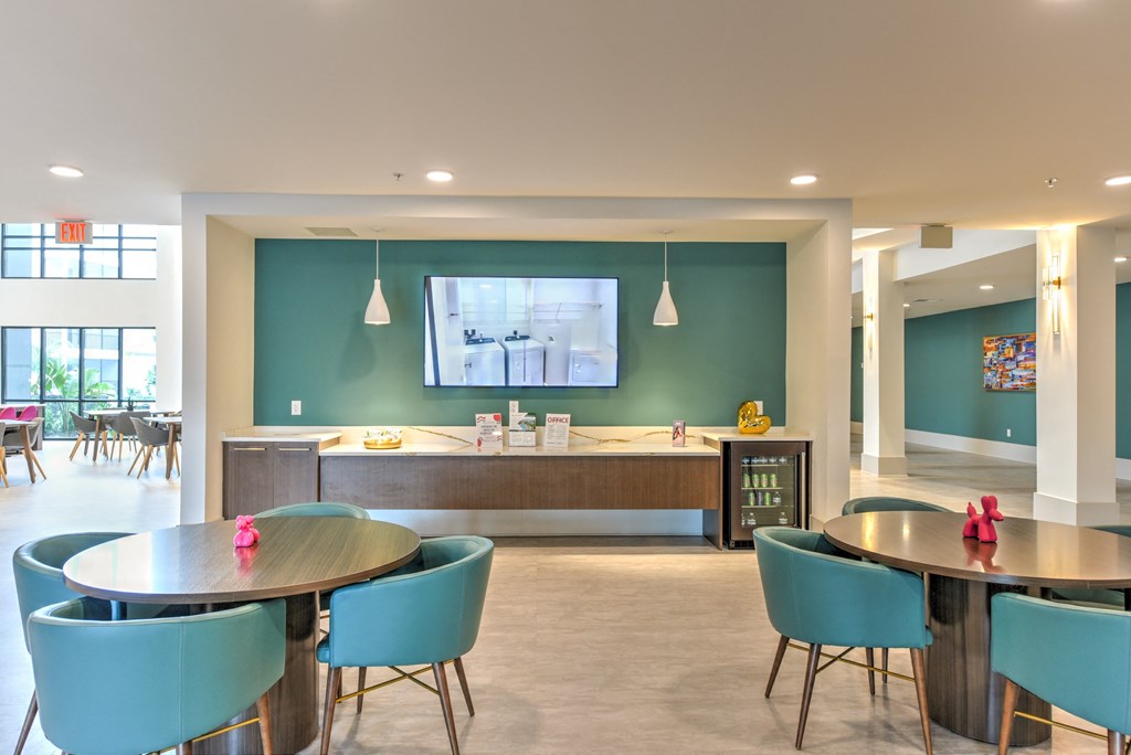 a dining room with tables and chairs and a tv on the wall at Pinnacle Apartments, Florida, 32256