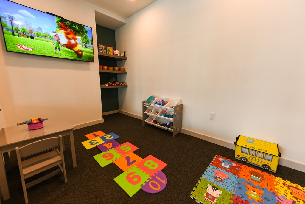 a childs play room with toys and a television at Pinnacle Apartments, Florida, 32256