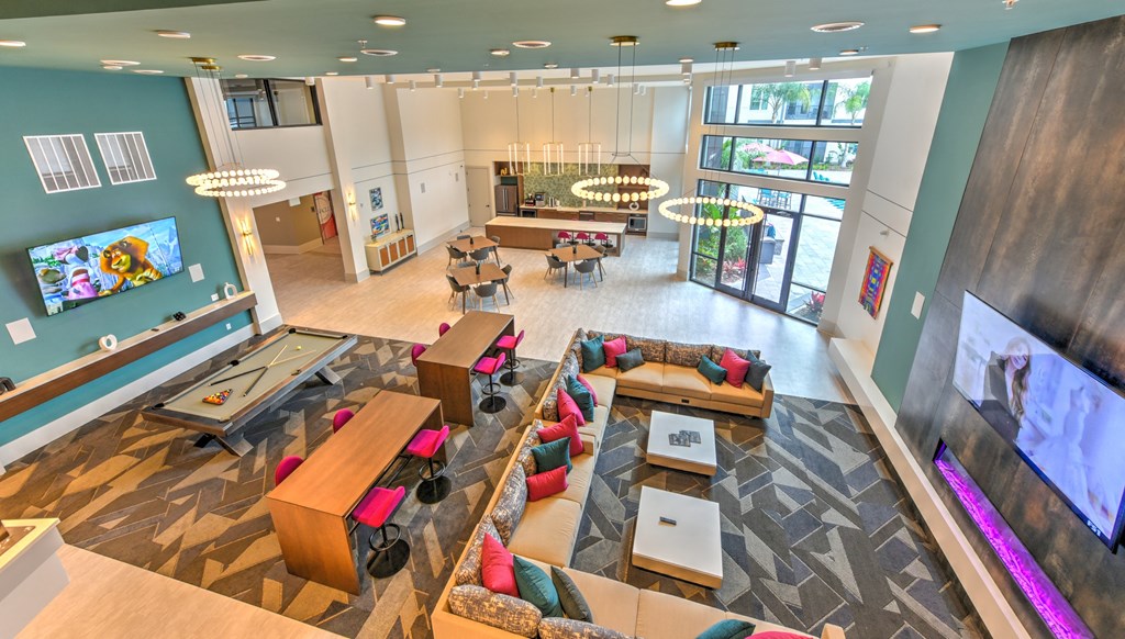 a large lobby with couches and tables and a tv at Pinnacle Apartments, Florida, 32256