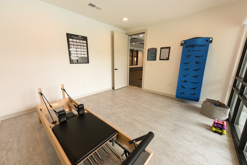 a room with a desk and a large blue climbing wall at Pinnacle Apartments, Florida, 32256