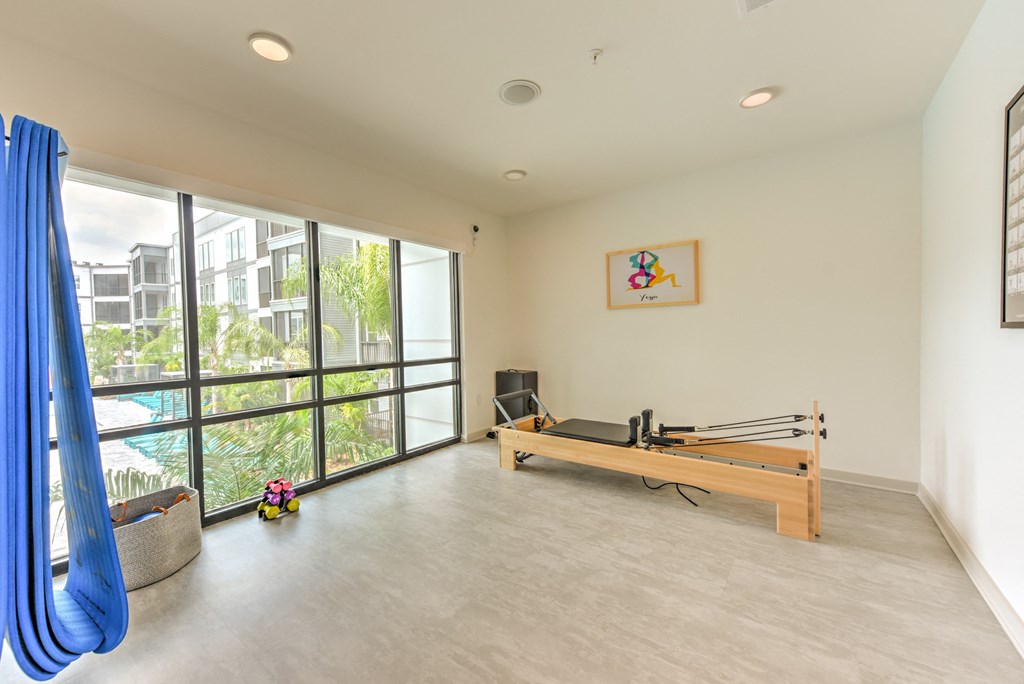 a room with a ping pong table and a large window at Pinnacle Apartments, Jacksonville, 32256