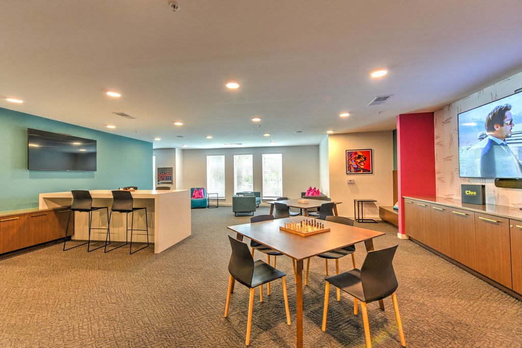 a conference room with a table and chairs and a tv at Pinnacle Apartments, Jacksonville, FL, 32256