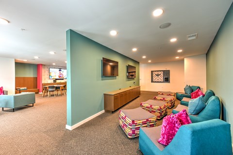 a living room with couches and chairs and a tv  at Pinnacle Apartments, Jacksonville