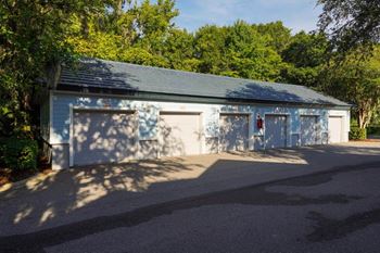 a small blue and white garage with two doors and trees in the background  at Ocean Park, Jacksonville Beach, FL, 32250