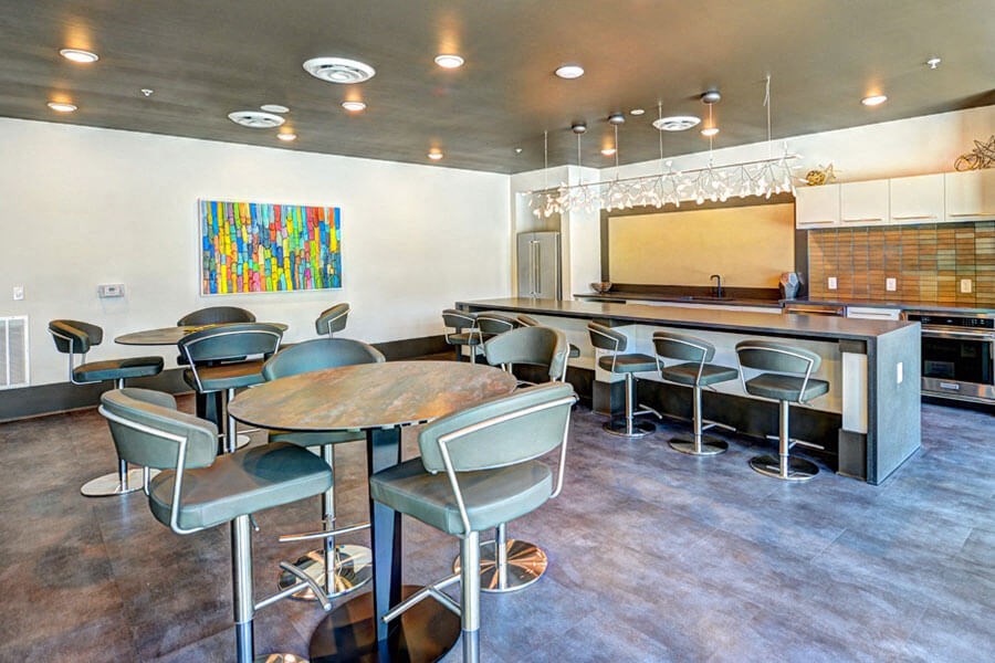 a room with a long table and chairs and a kitchen in the background a room with a long table and chairs and a kitchen in the background at Fusion, Jacksonville, FL, 32256