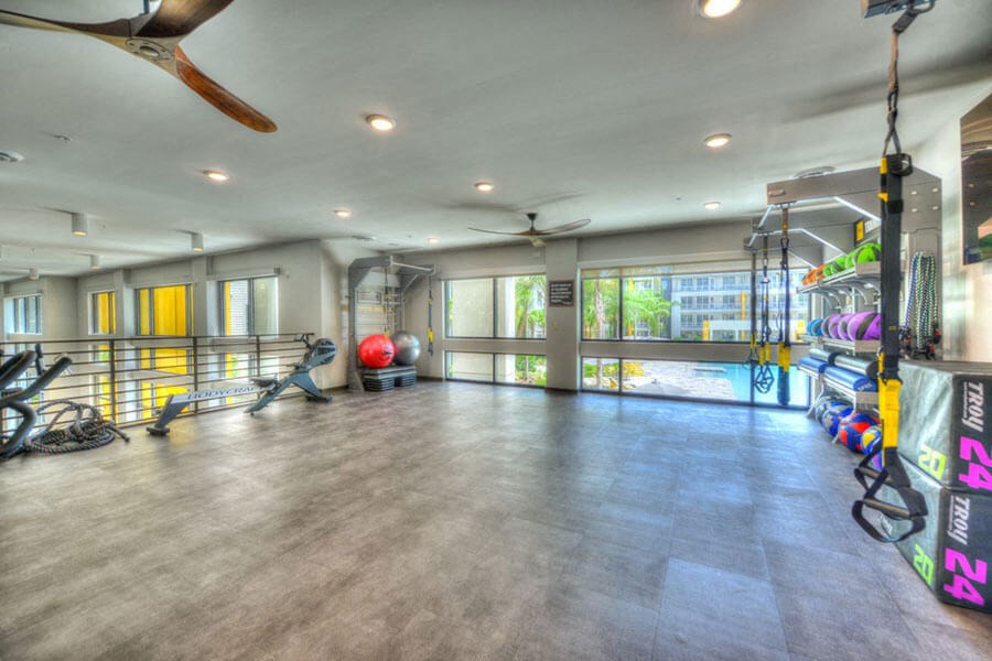 a workout room with a treadmill and weights at the preserve at great pond apartments in windsor  at Fusion, Florida