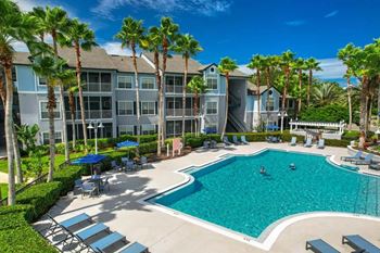 Refreshing pool, lounge chair and umbrellas  at Ocean Park, Jacksonville Beach, FL