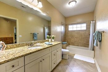 Spacious bathrooms with granite counters, tile floors and lots of vanity space  at Ocean Park, Jacksonville Beach, 32250