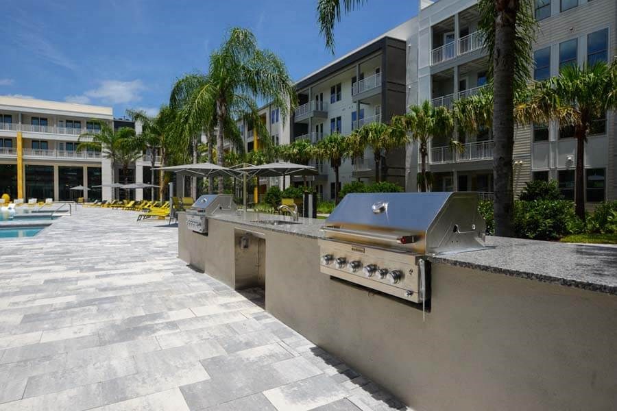a kitchen with a stove top oven next to a swimming pool  at Fusion, Florida, 32256