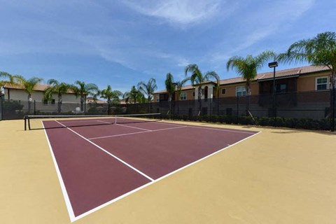 a tennis court with palm trees in the background  at Hacienda Club, Jacksonville, 32256