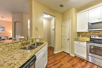 Kitchen with granite counters, pantry and stainless steel appliances  at Ocean Park, Jacksonville Beach