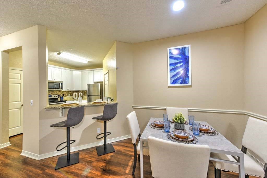 a dining room with a table and chairs next to a kitchen  at Ocean Park, Jacksonville Beach