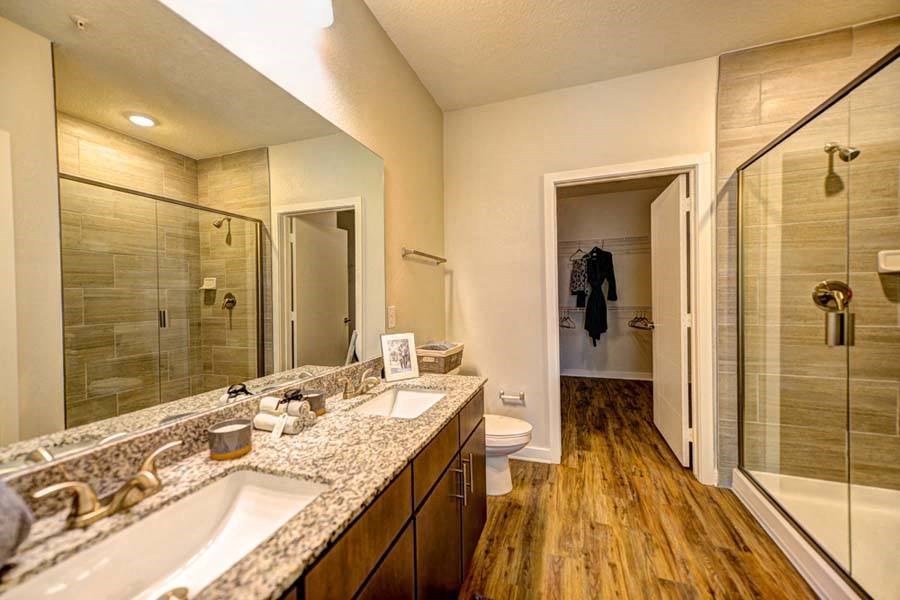 a bathroom with a large mirror and a toilet  at Fusion, Jacksonville, FL, 32256