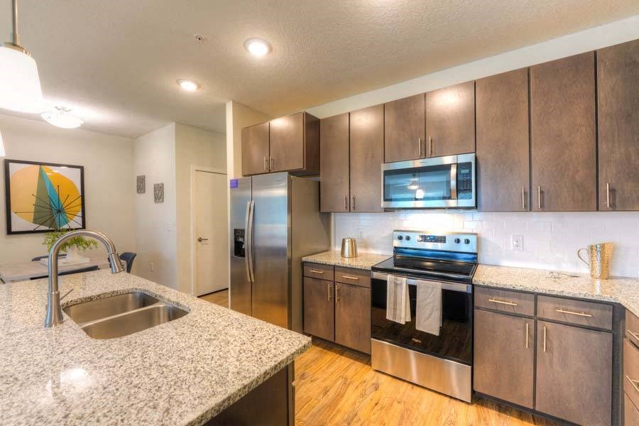 a kitchen with a sink stove and refrigerator  at Fusion, Florida