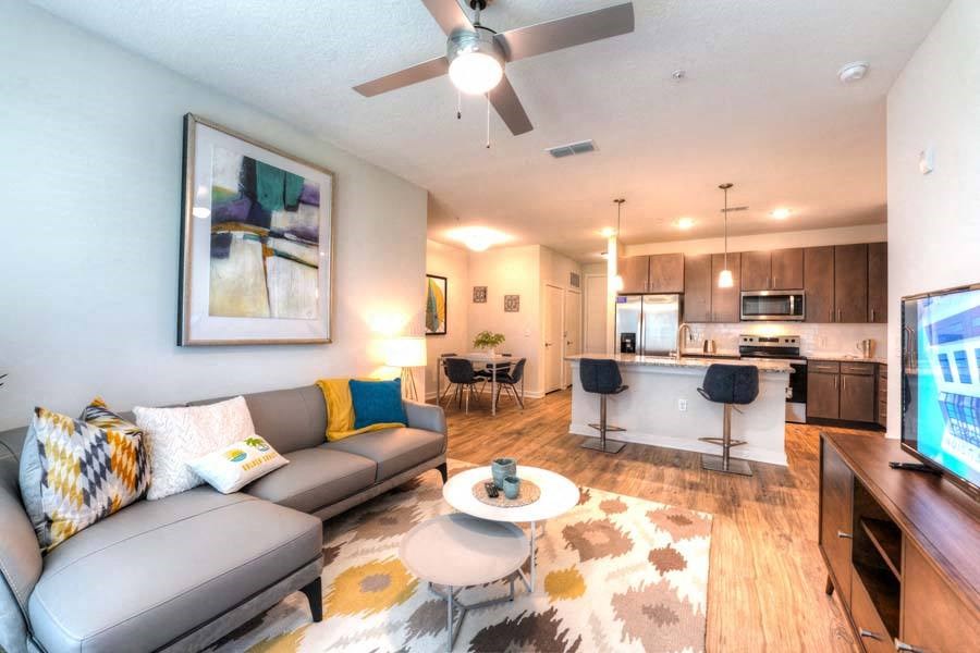 a living room with a couch a table and a tv  at Fusion, Jacksonville, FL, 32256