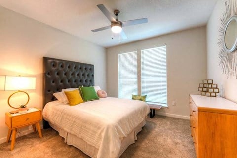 a bedroom with a large bed and a ceiling fan  at Fusion, Jacksonville, 32256