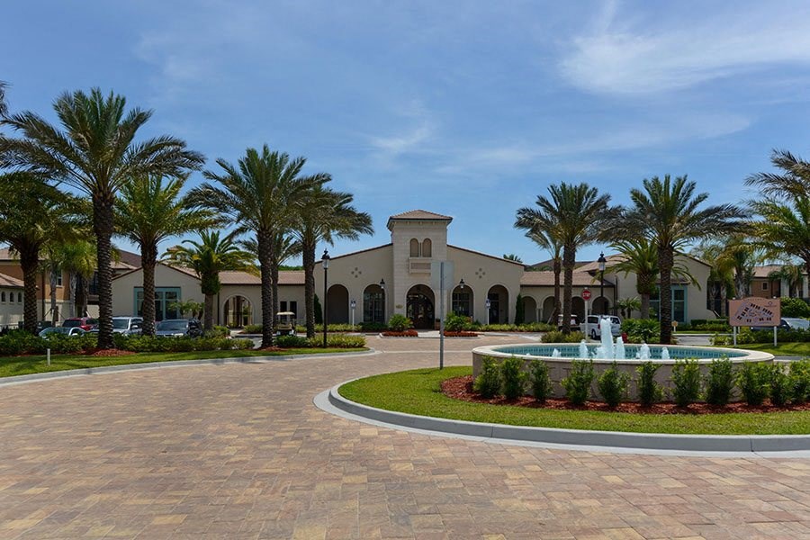 a roundabout with a fountain in front of a building  at Hacienda Club, Jacksonville, FL