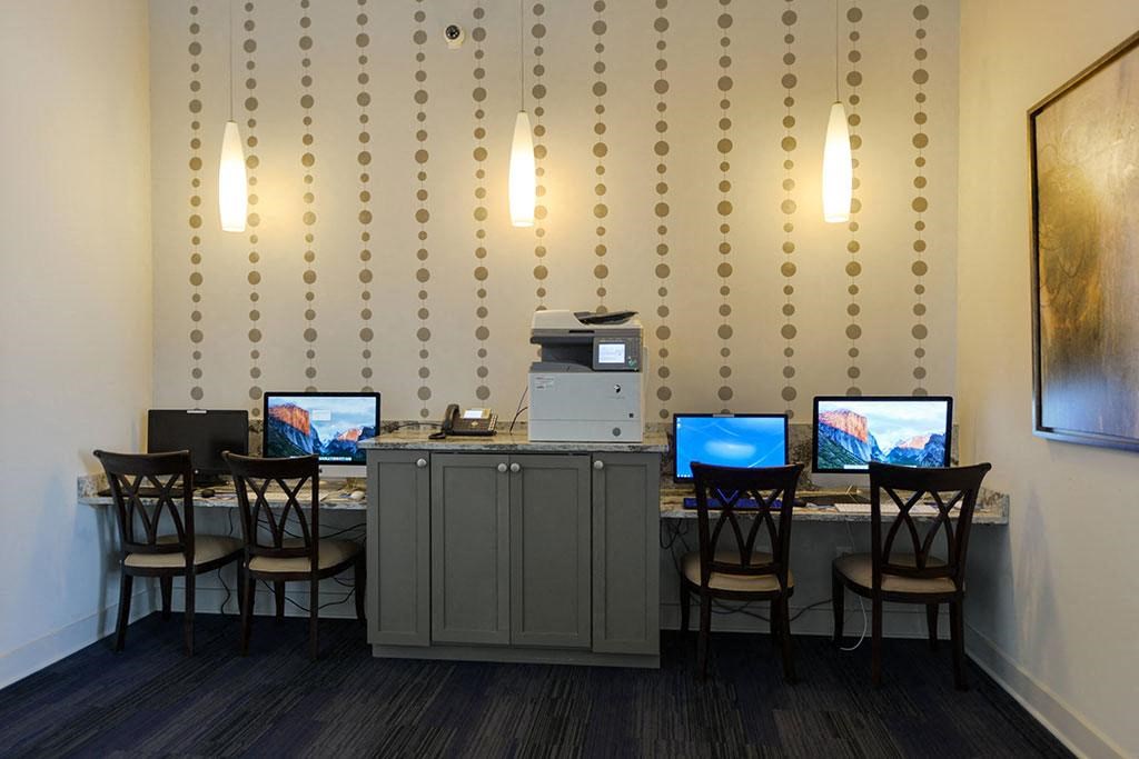 a room with a bunch of computers on a table  at Cabana Club - Galleria Club, Florida, 32256
