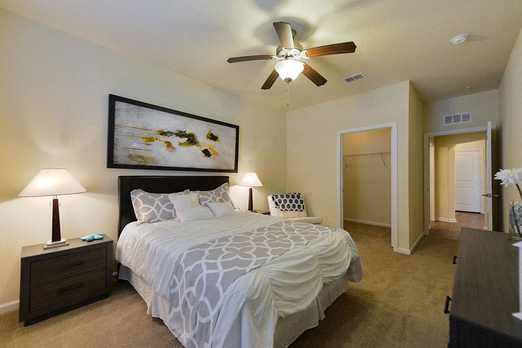 a bedroom with a bed and a ceiling fan  at Cabana Club - Galleria Club, Jacksonville, FL
