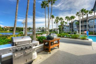 a barbecue grill sitting next to a table with a kettle on it  at Ocean Park, Florida, 32250