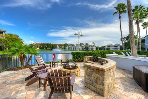 a patio with a fire pit and a lake in the background  at Ocean Park, Florida