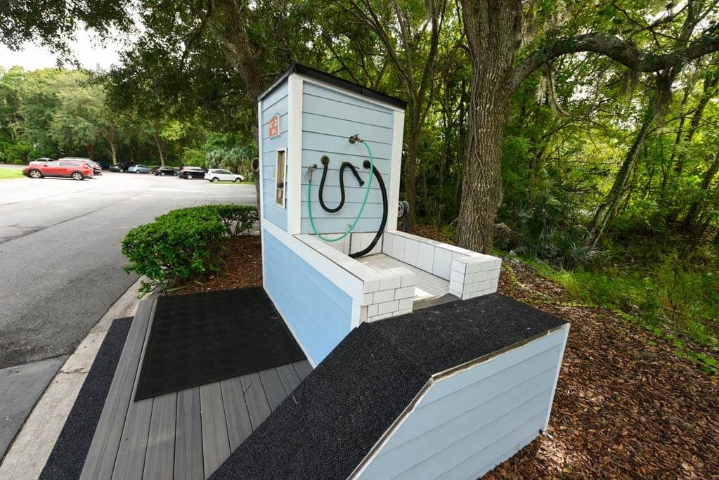 a bench with a hose on it next to a road  at Ocean Park, Jacksonville Beach, FL, 32250