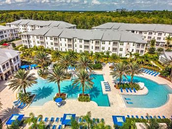 an aerial view of a resort with a large swimming pool  at Palm Bay Club, Florida, 32258