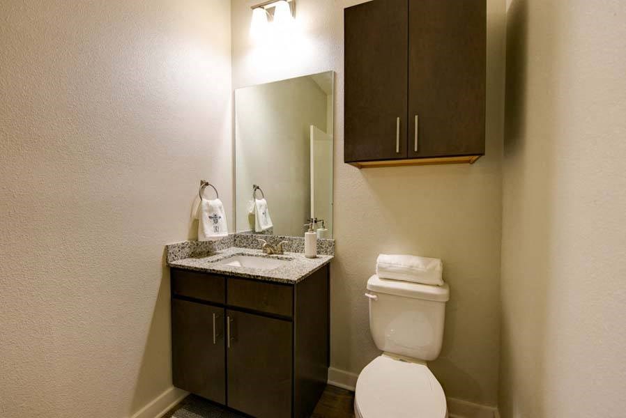 a bathroom with a toilet sink and mirror  at Fusion, Jacksonville, FL, 32256