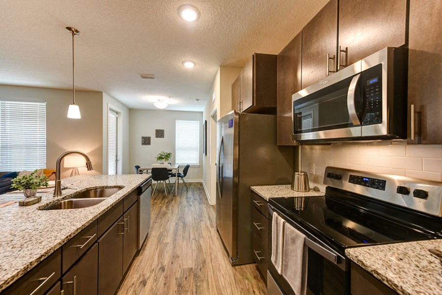 a kitchen with a stove top oven next to a sink  at Fusion, Florida, 32256