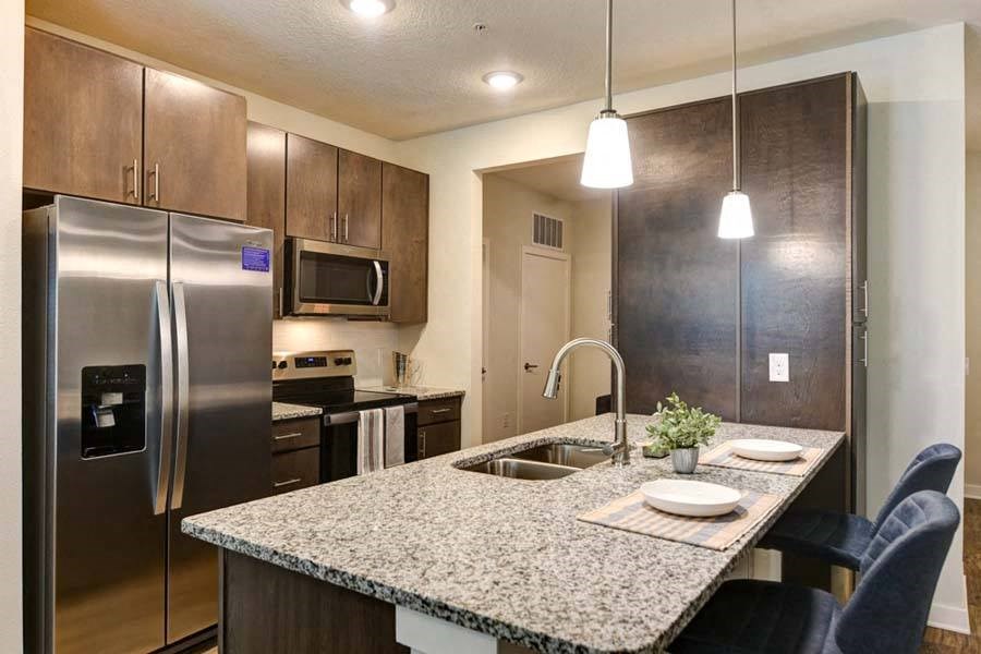 a kitchen with a sink a stove and a refrigerator  at Fusion, Florida