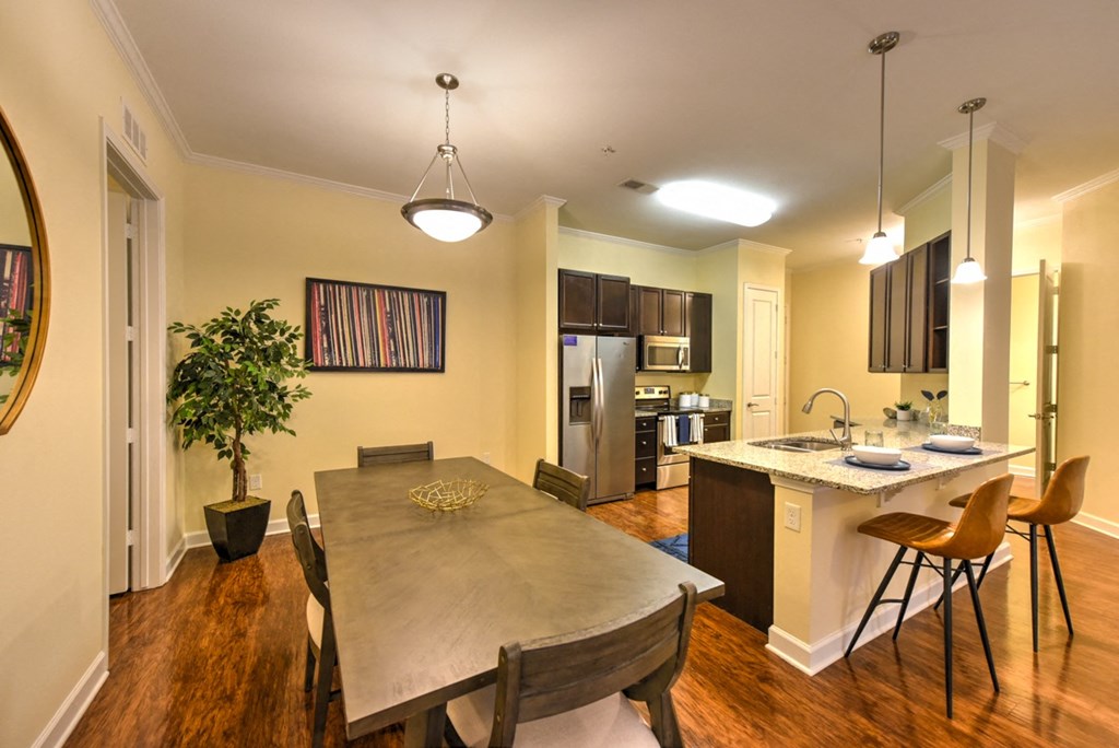 A dining room with a wooden table and chairs at Alaqua, Florida, 32258
